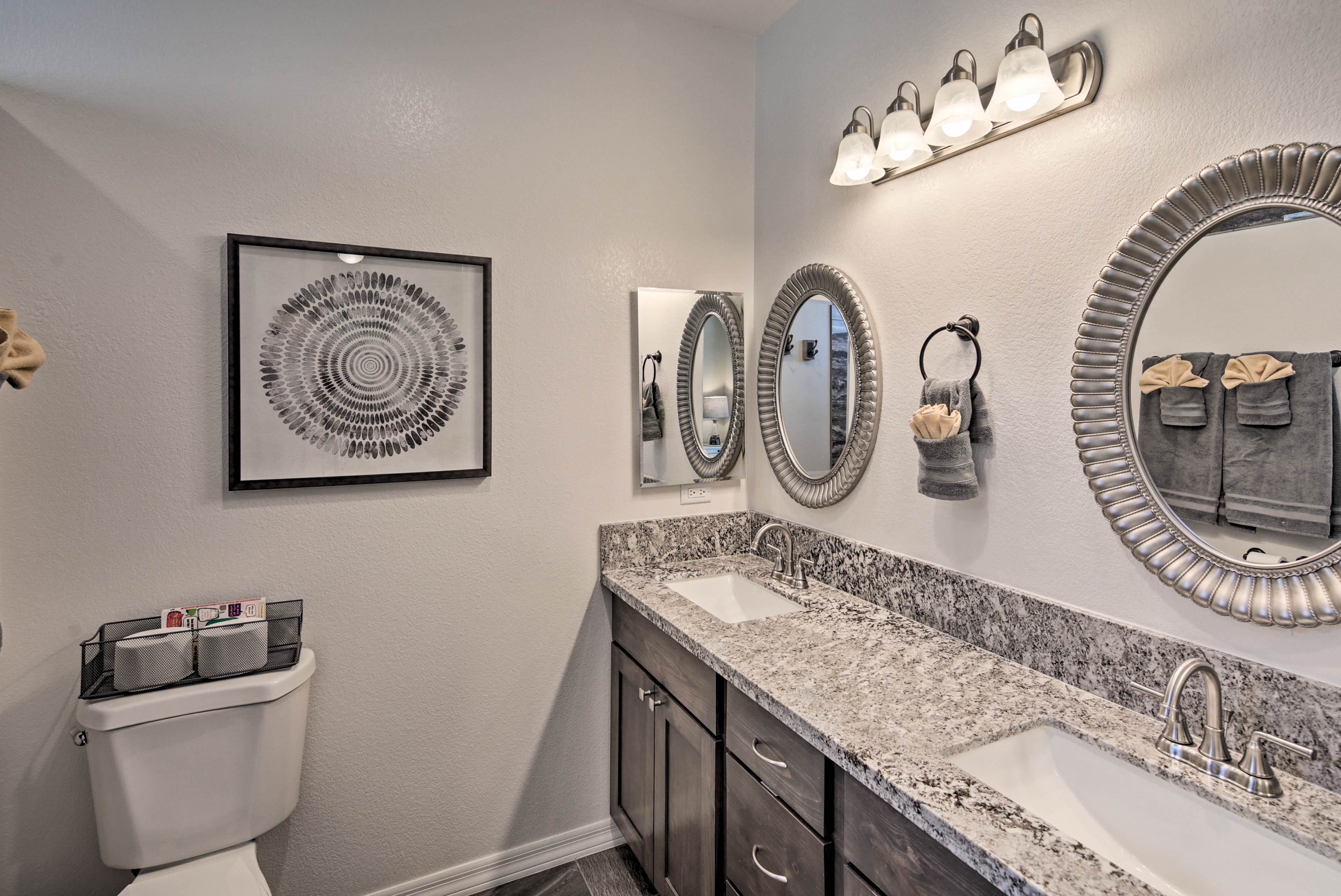 The en-suite bathroom features dual sinks.