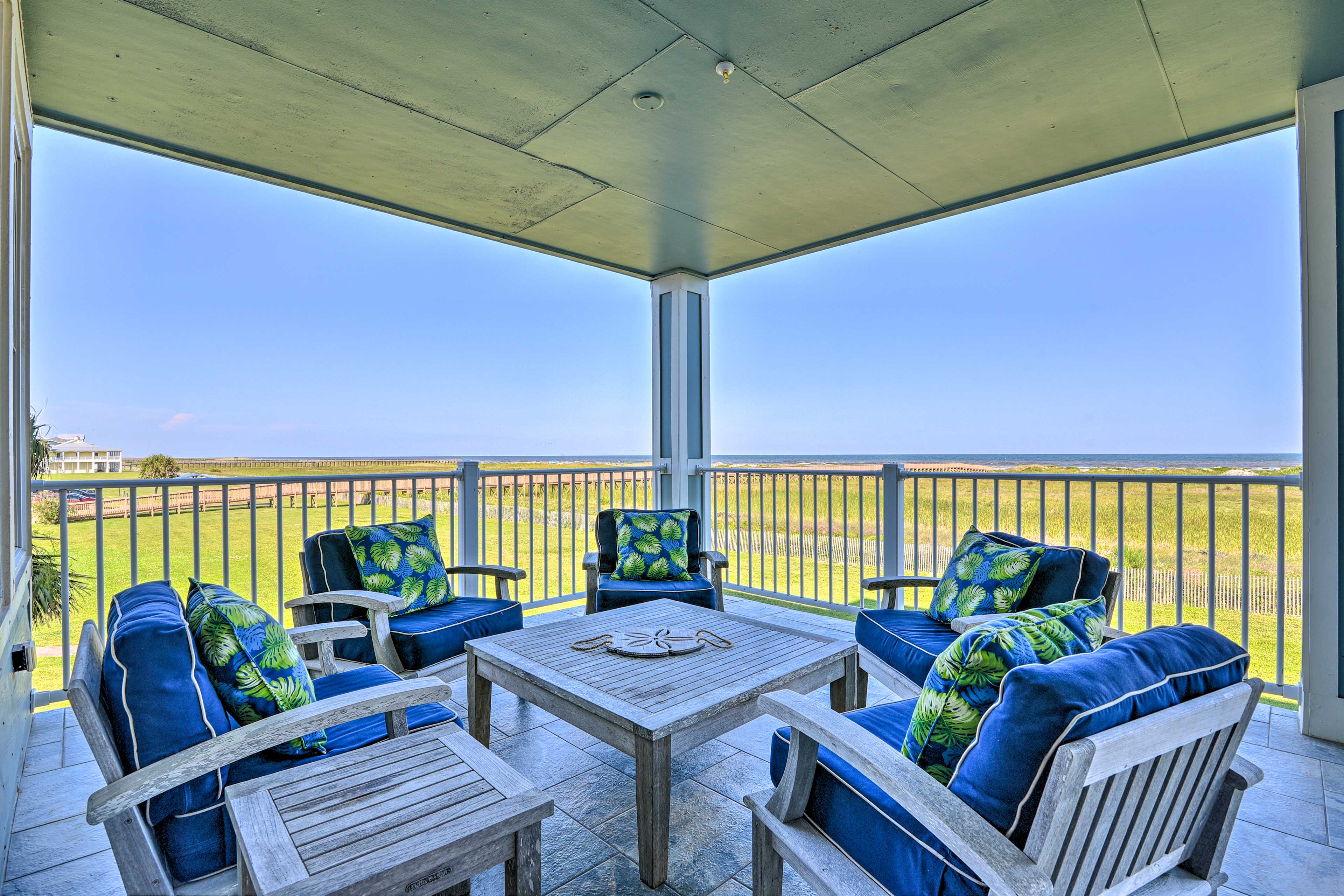 Sit on this vacation rental's covered balcony and take in the gulf view.