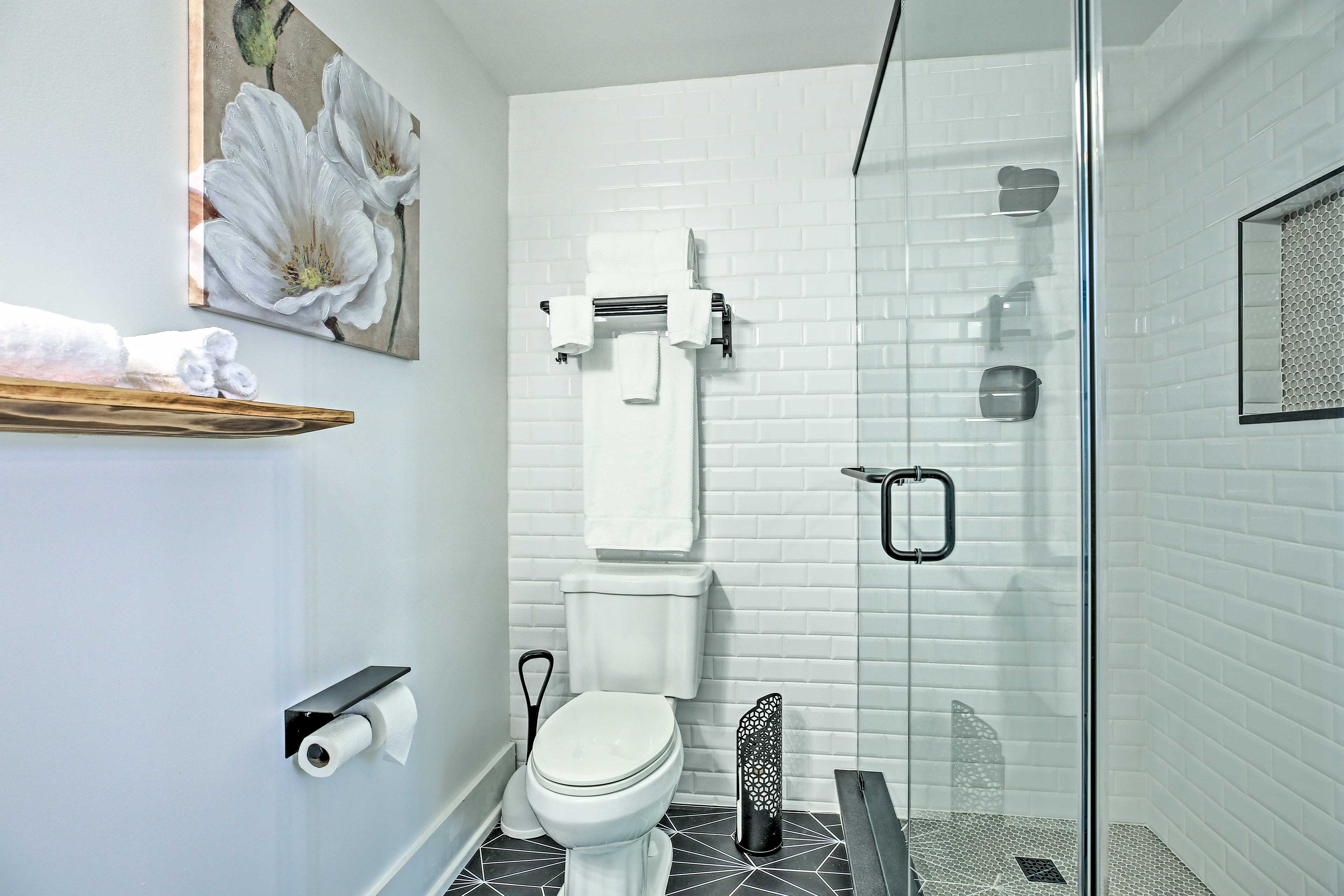 The second bathroom has tasteful black-and-white tiling.