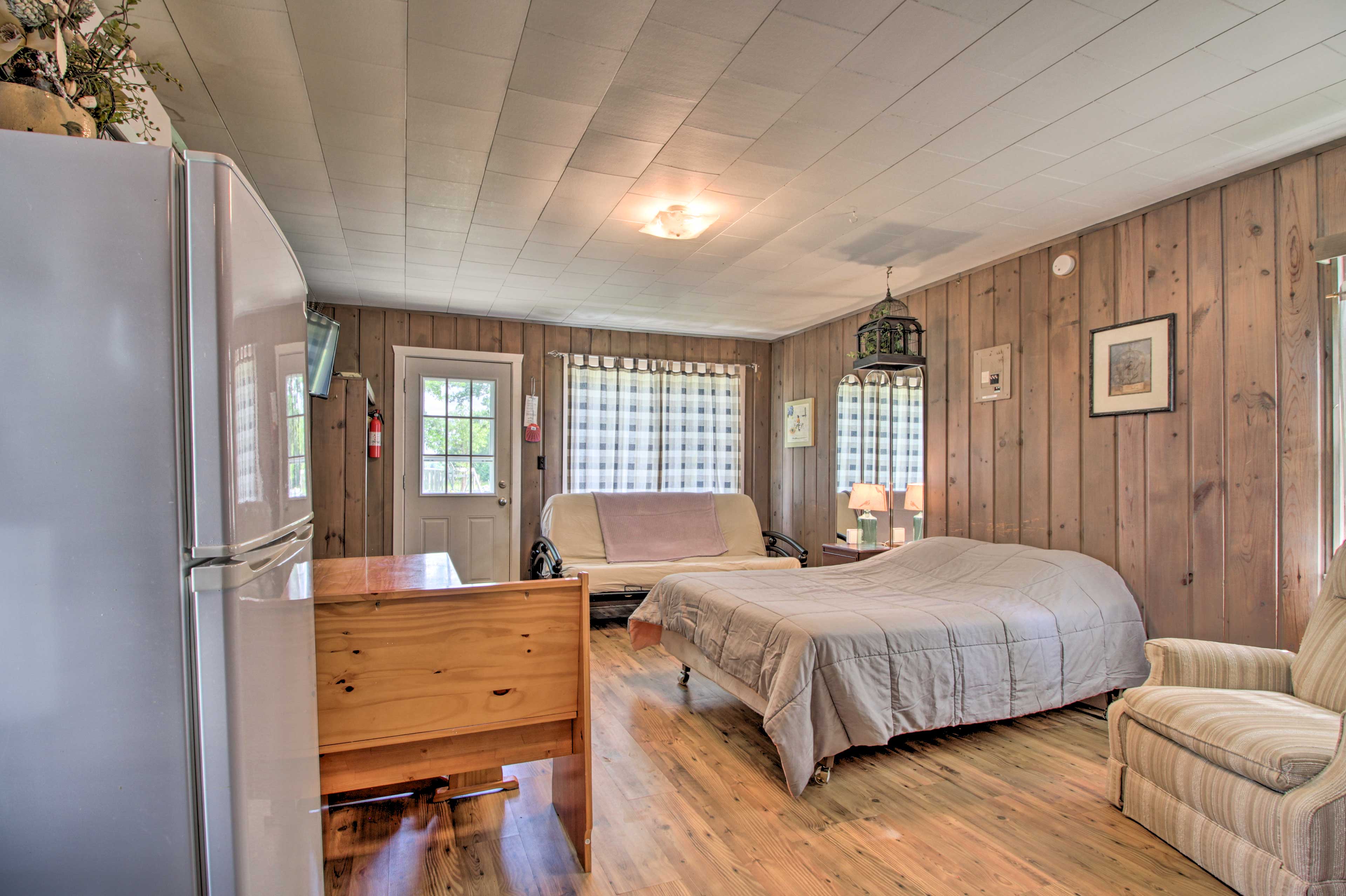 A full beds rests in the main living area.