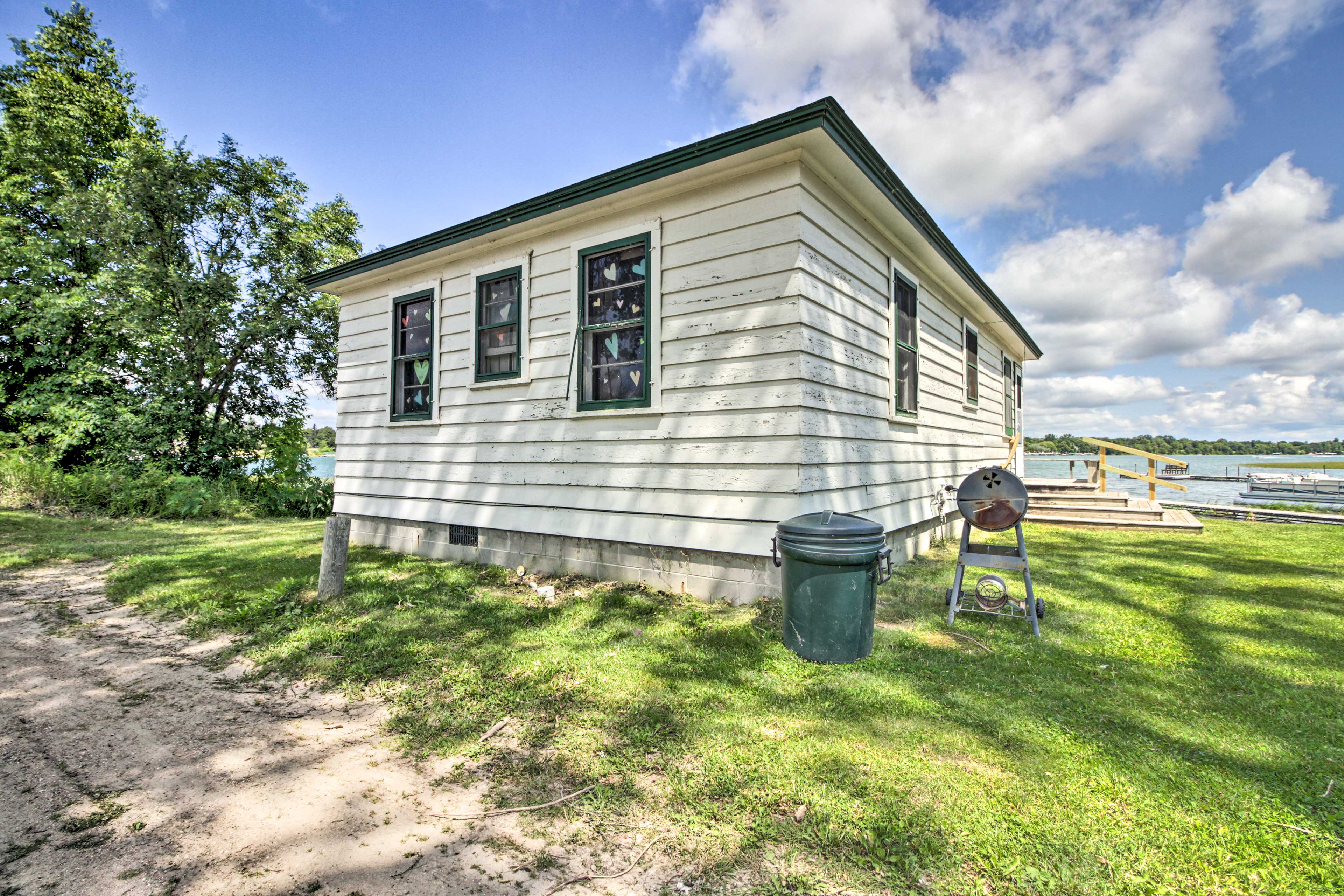 This home has plenty of yard space and a charcoal grill.