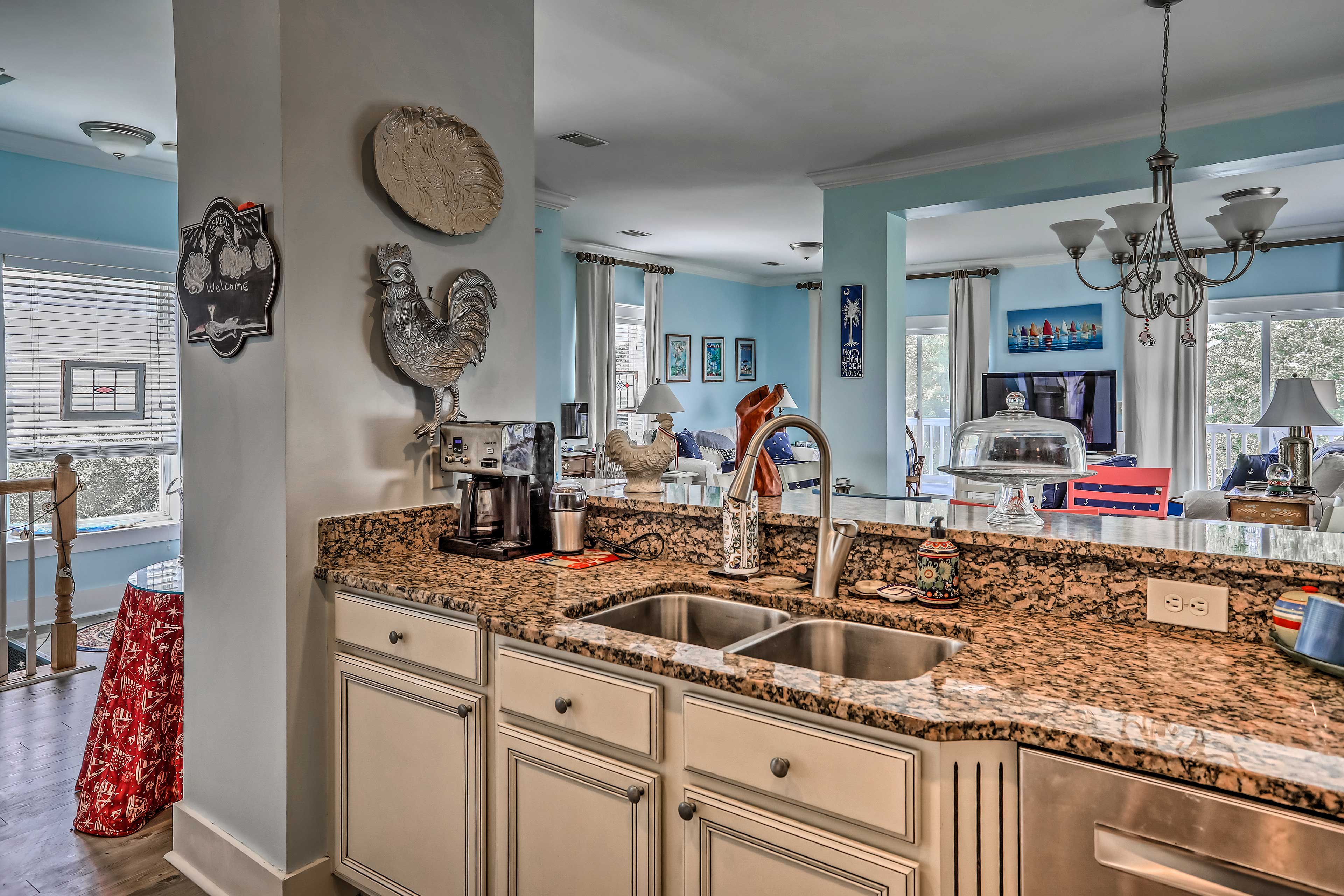 The full kitchen boasts granite counters and overlooks the living area.
