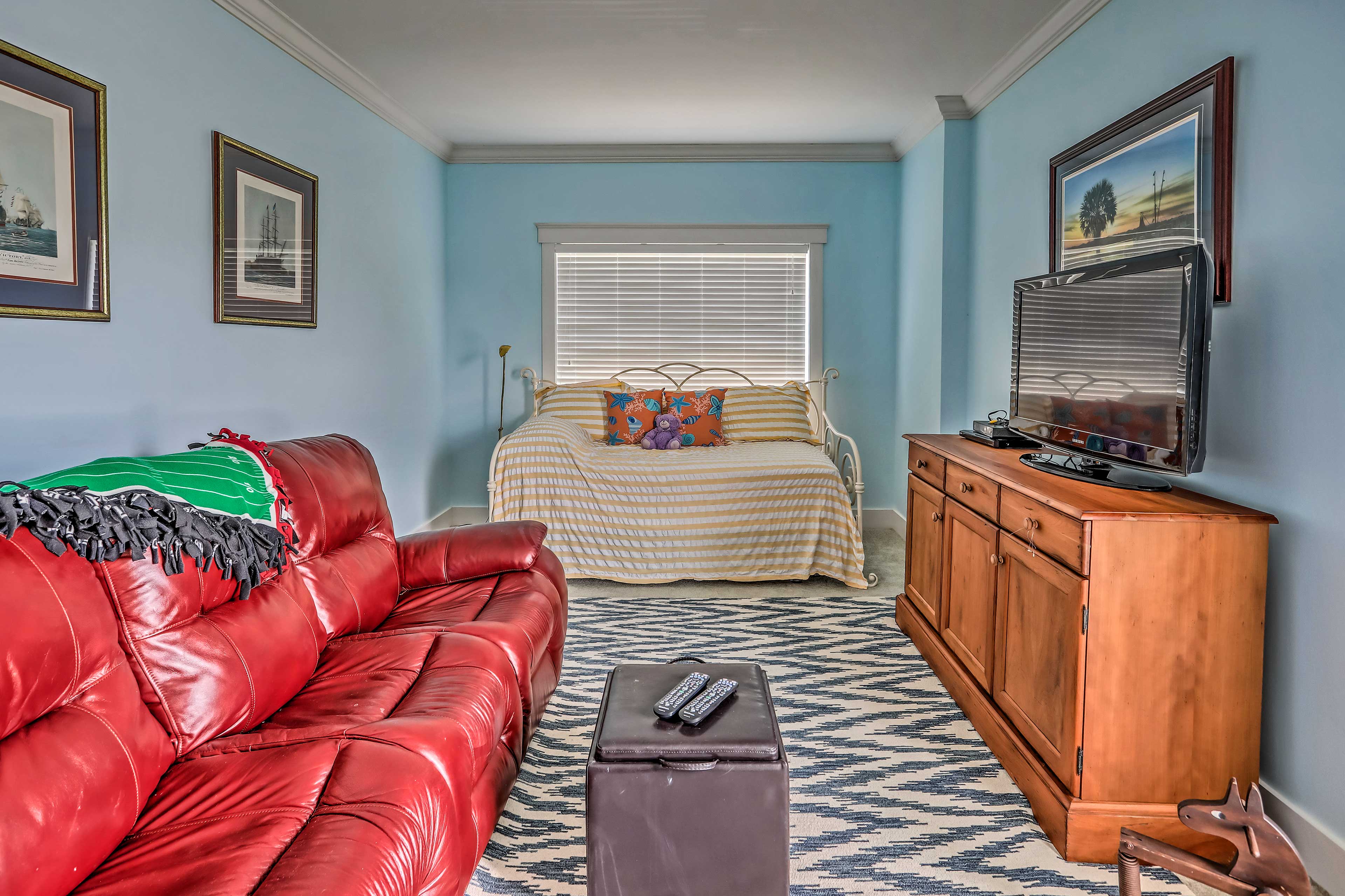 The upstairs landing hosts a twin daybed with a trundle, along with a TV.
