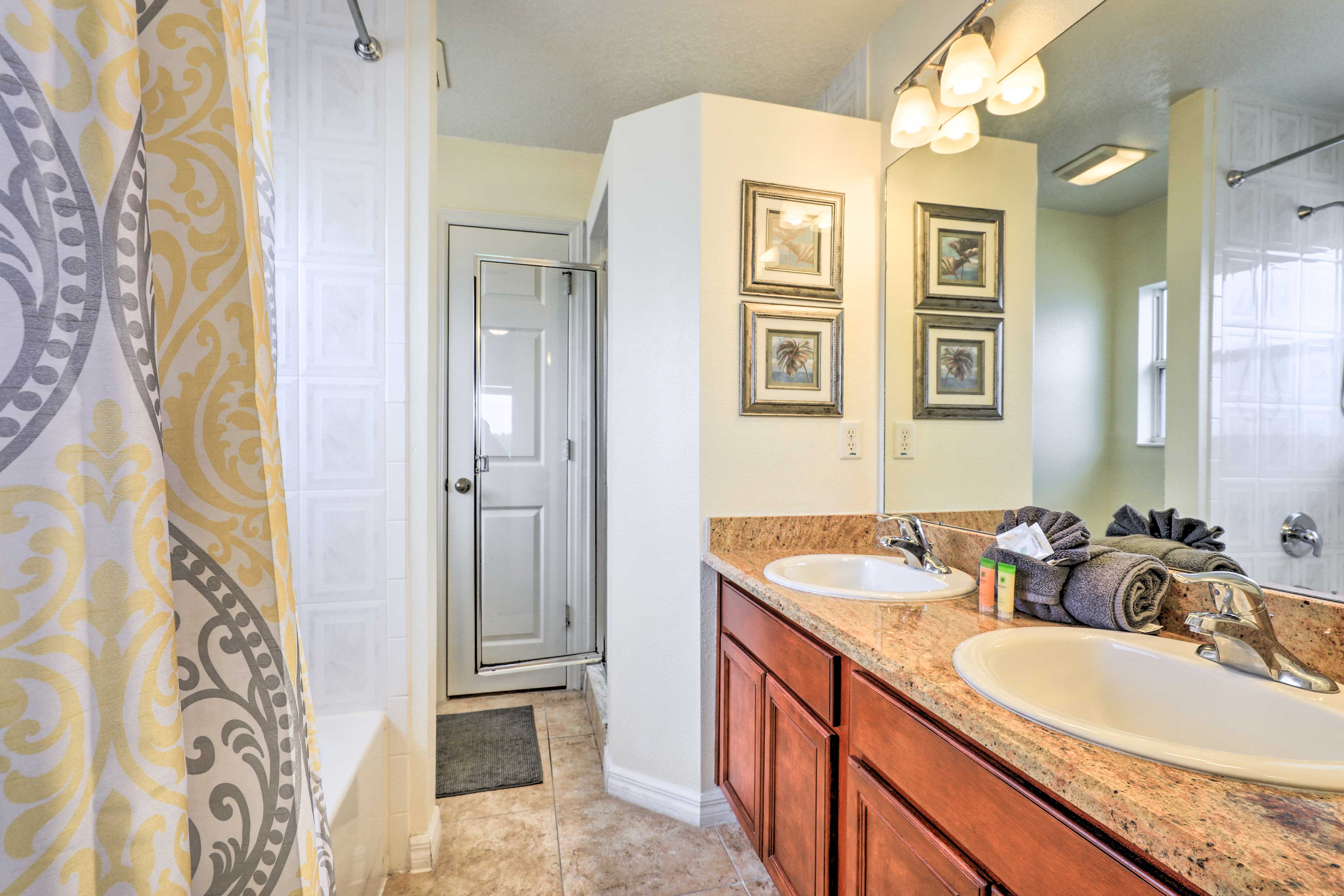 This en-suite bath boasts dual sinks and a shower/tub combo.