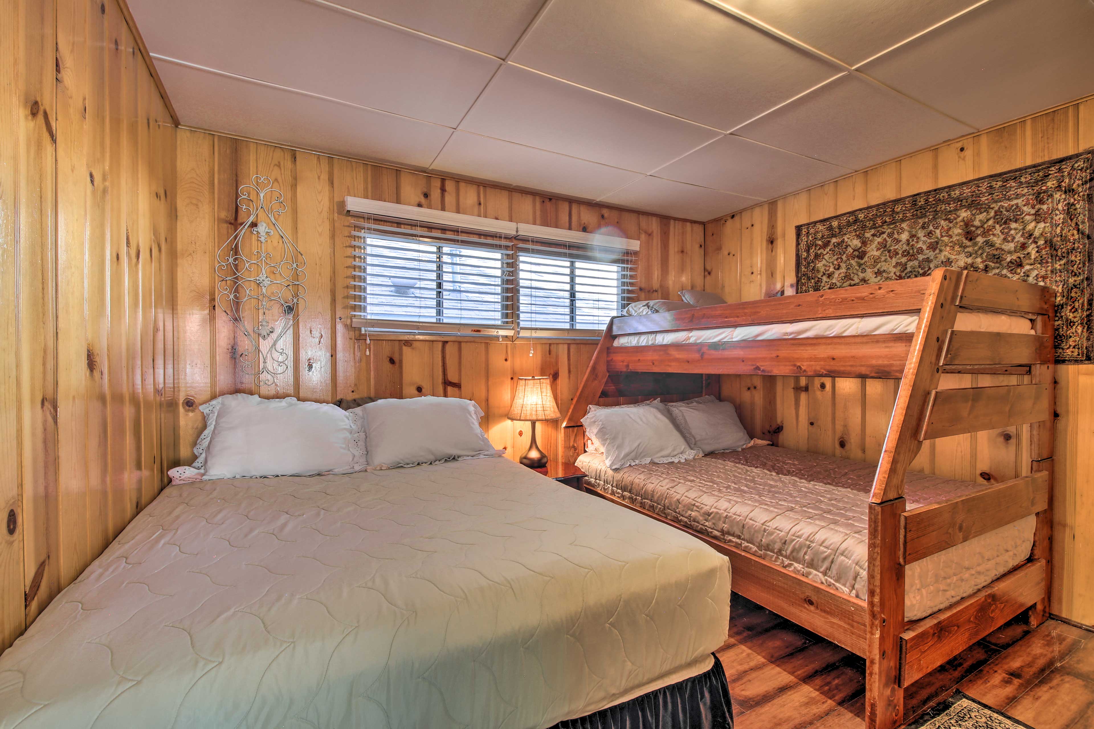 The second bedroom hosts a twin-over-full bunk bed and a queen-sized bed.