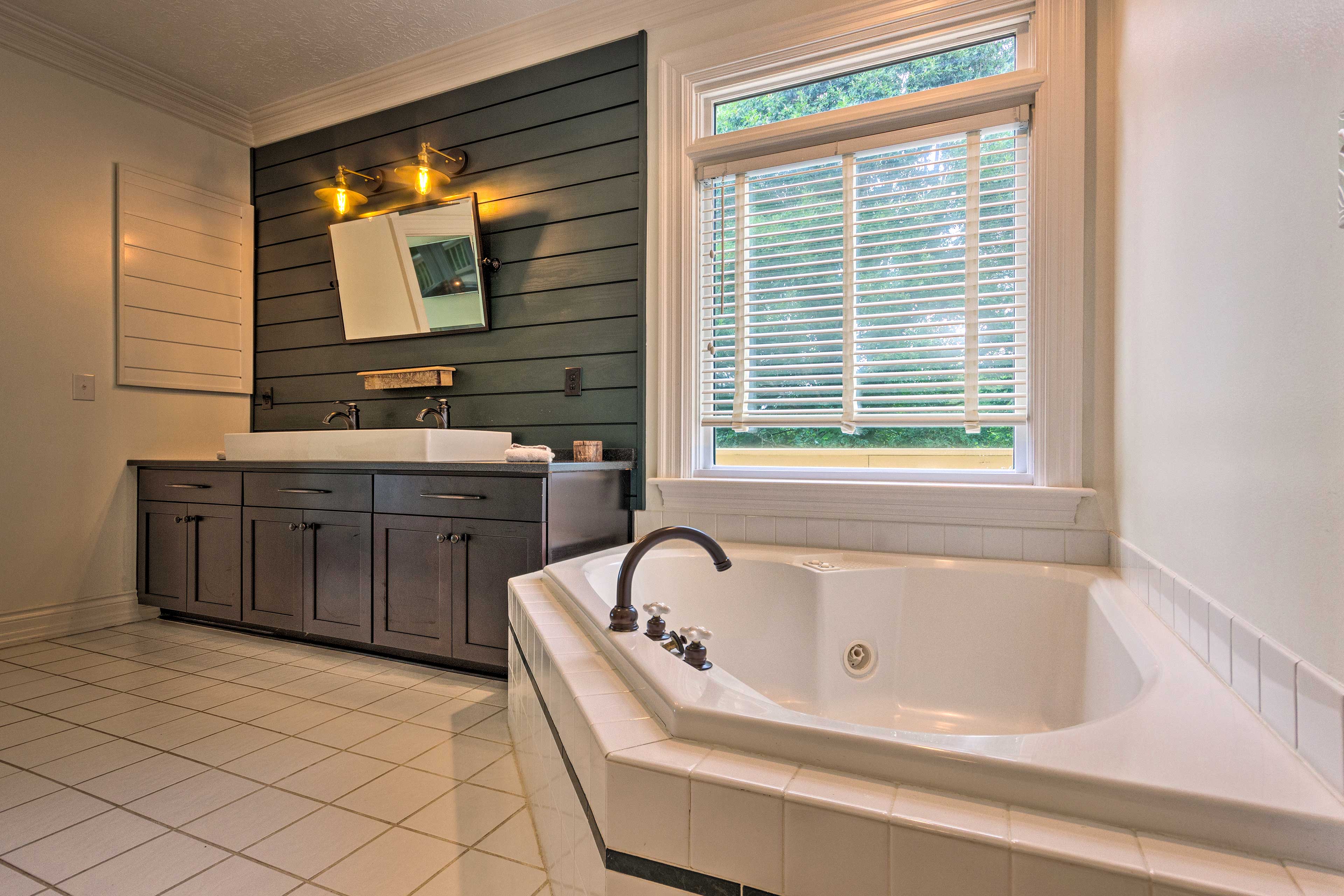 This full bathroom has relaxation written all over it with a jetted tub.