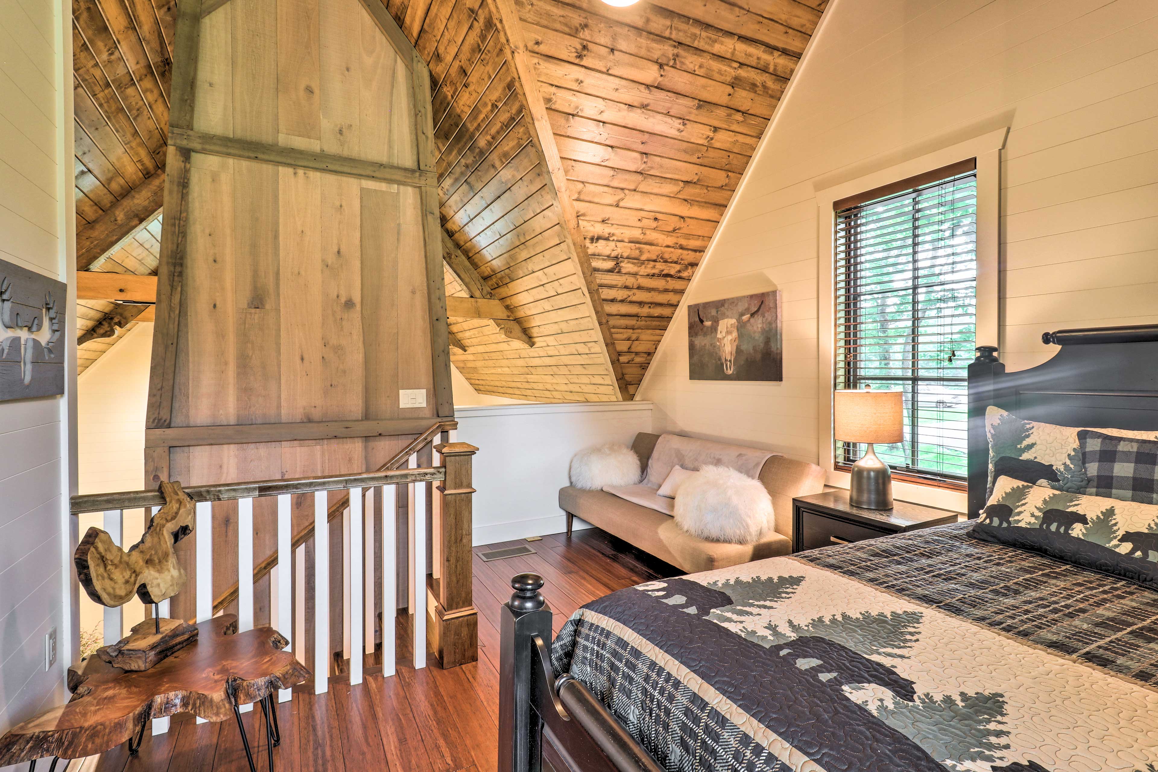 Head upstairs to the loft space, which features a queen bed & futon.