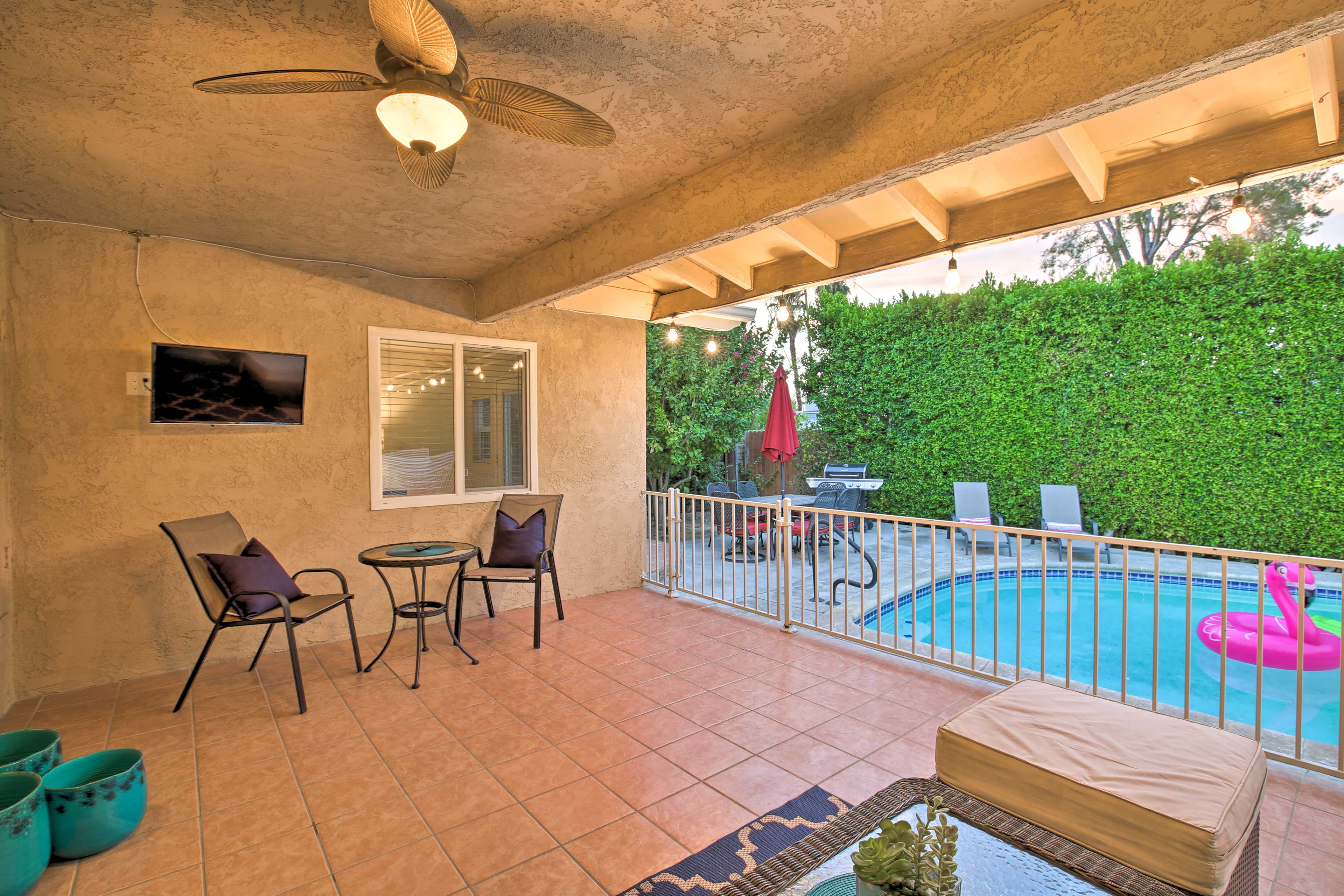 The vacation rental features a furnished patio with an outdoor flat-screen TV.