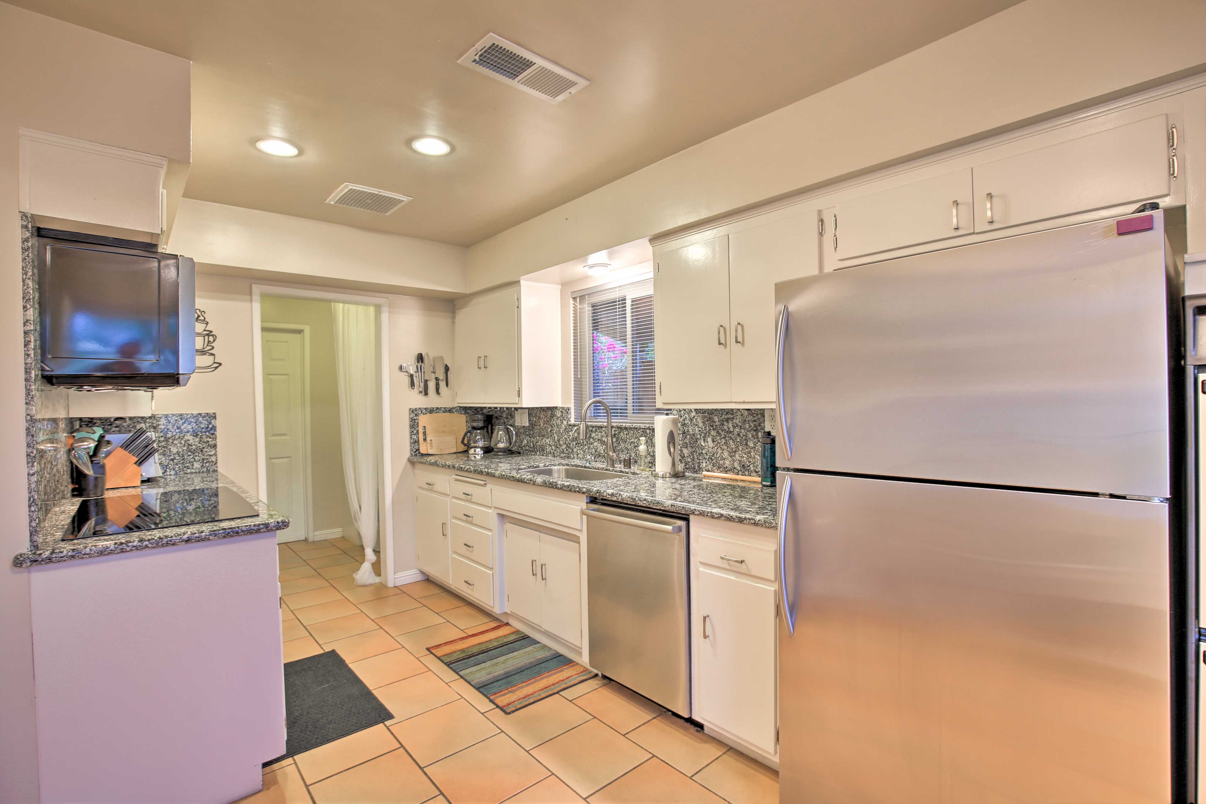 The kitchen comes fully equipped with stainless steel appliances.
