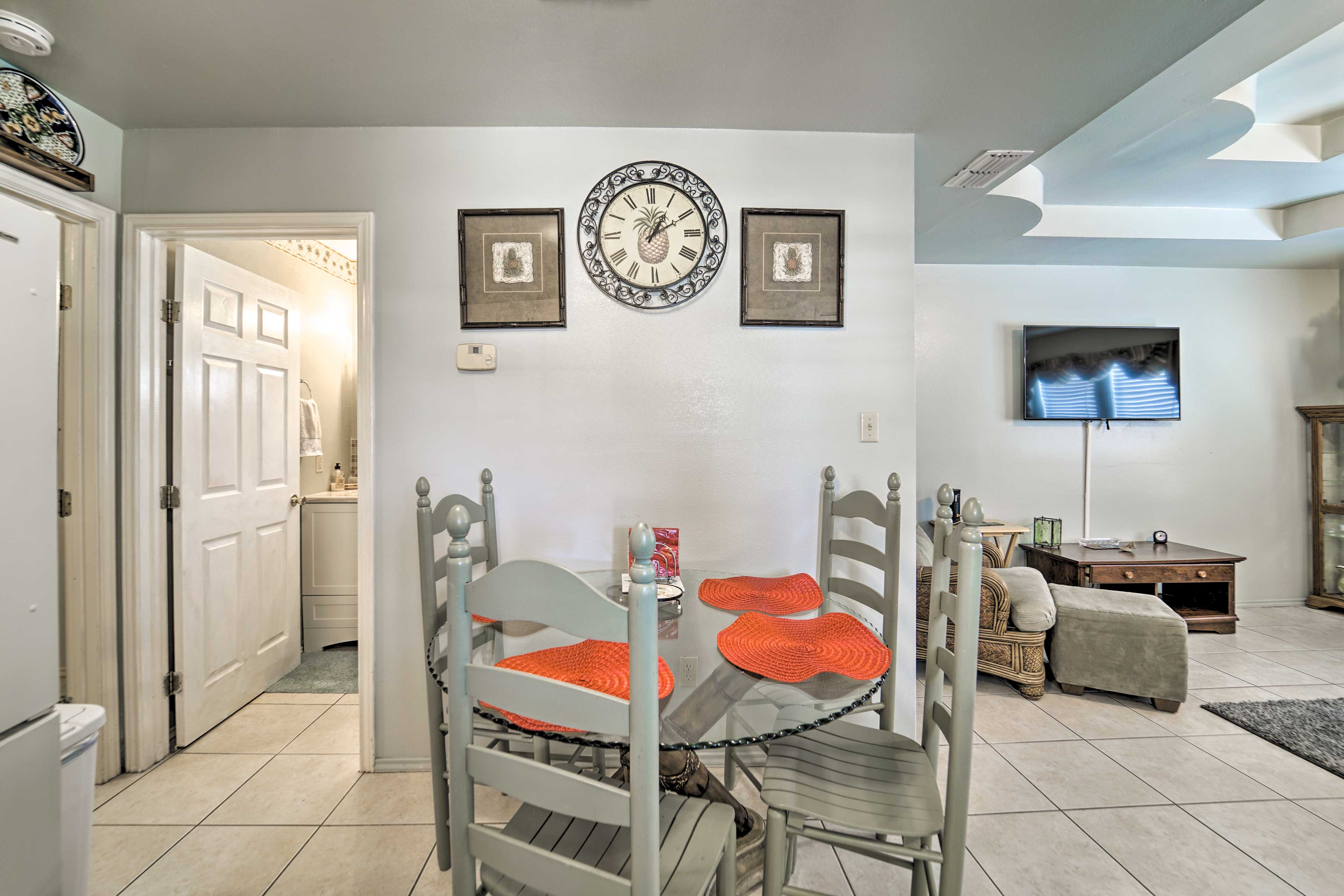 Set the glass dining table for a formal meal.