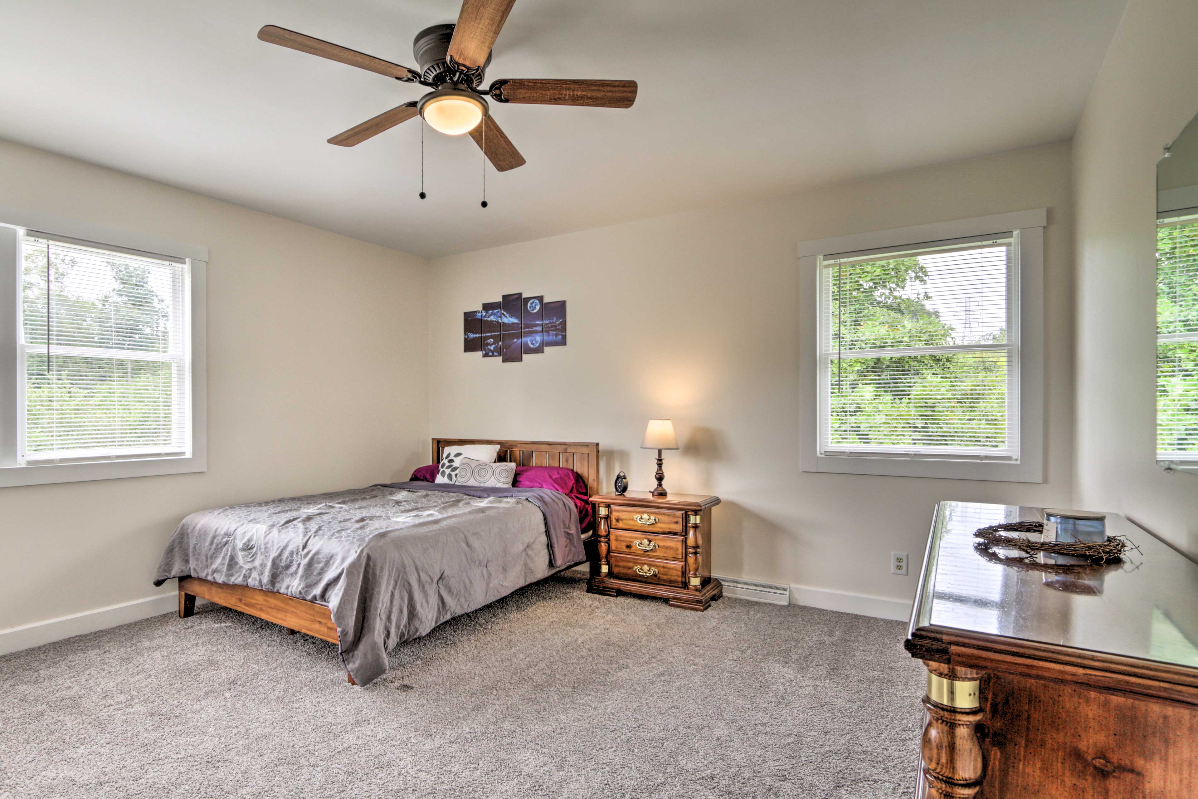 The main bedroom hosts a queen bed.