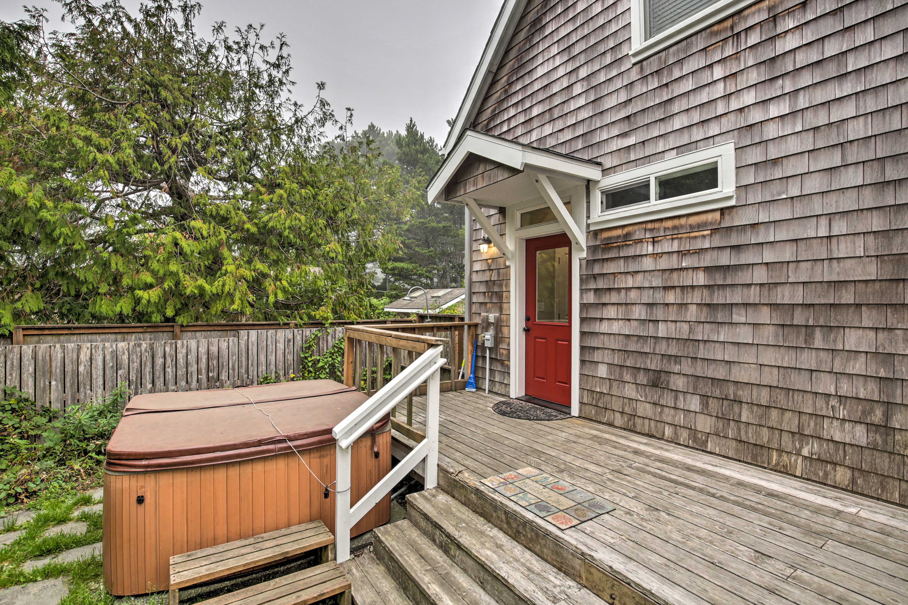 The spacious home boasts a deck and backyard! (Hot Tub Currently Unavailble)