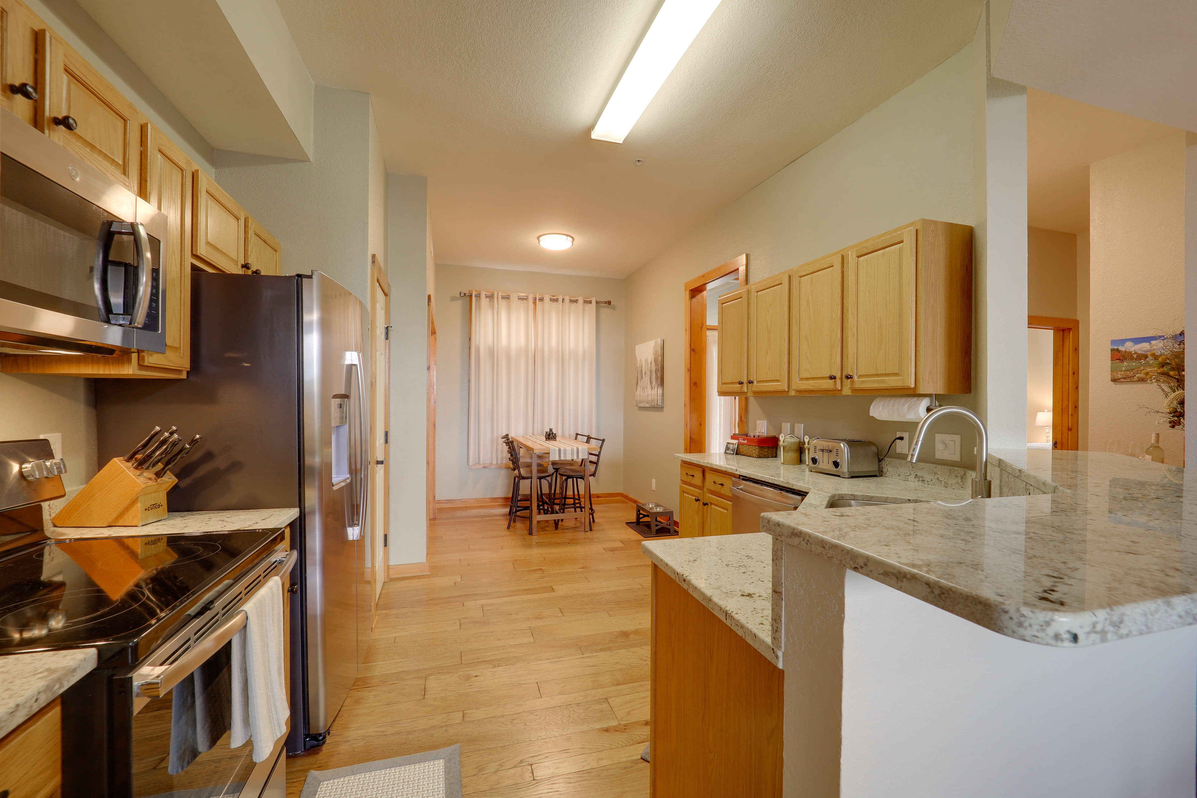 Fully Equipped Kitchen | Breakfast Table | In-Unit Laundry Machines