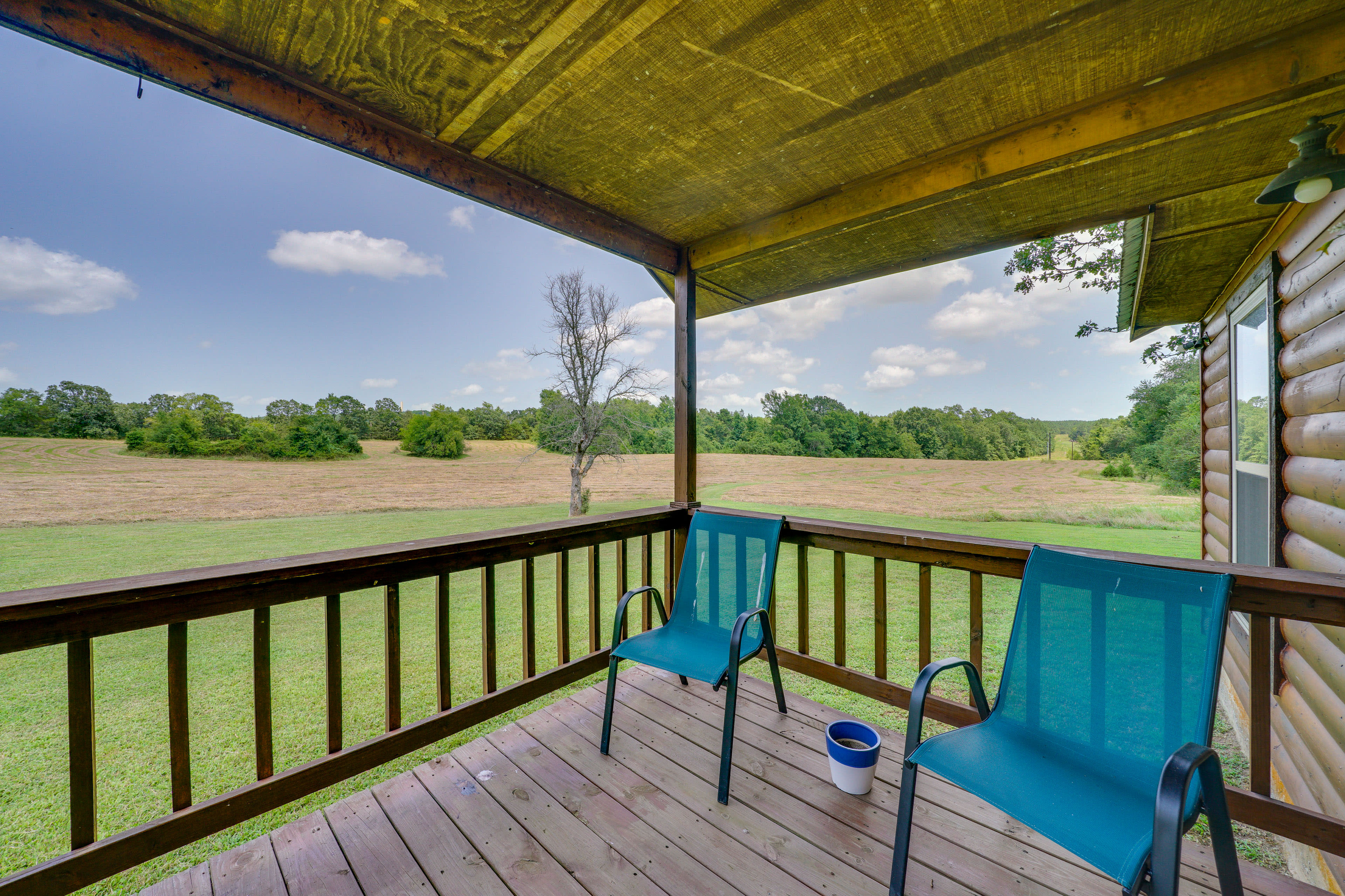 Covered Front Porch | Charcoal Grill | 80 Acres | Single-Story Cabin