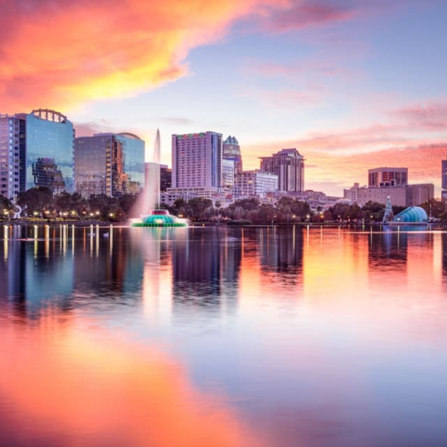Orlando, Florida skyline with a fountain at sunset