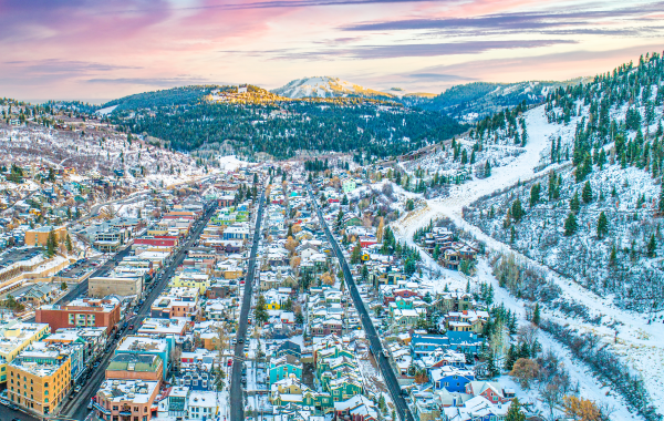 arial view of Downtown Park City with snowcapped mountains in the distance