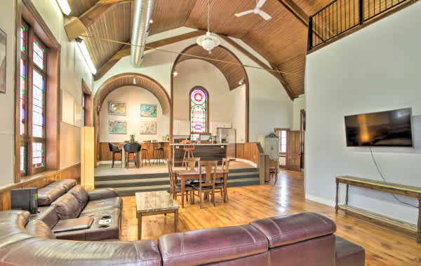 Interior shot of a converted church vacation rental with a living room and TV area