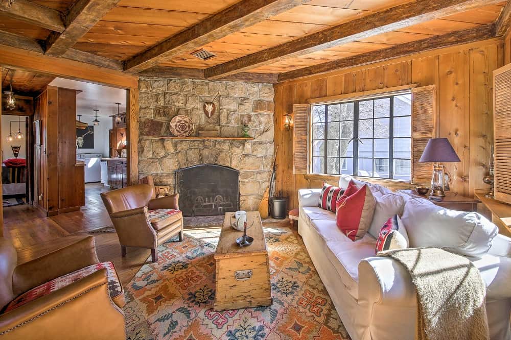 Mountain cabin living room with stone fireplace and cozy accents