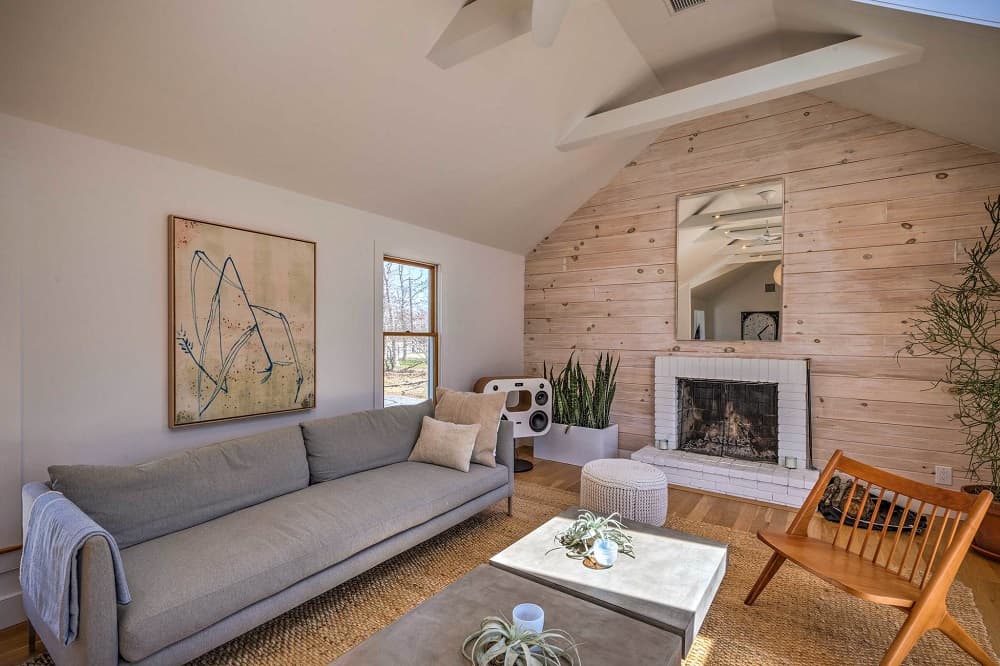 Vacation rental living room with seating arranged around fireplace