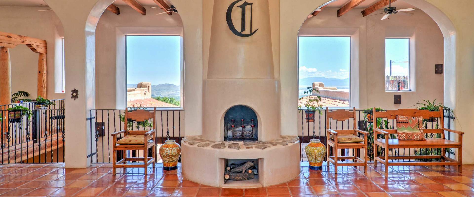 Photo of an interior space at a vacation rental near Los Cerrills, New Mexico. The Spanish style rental overlooks breathtaking views in the distance.