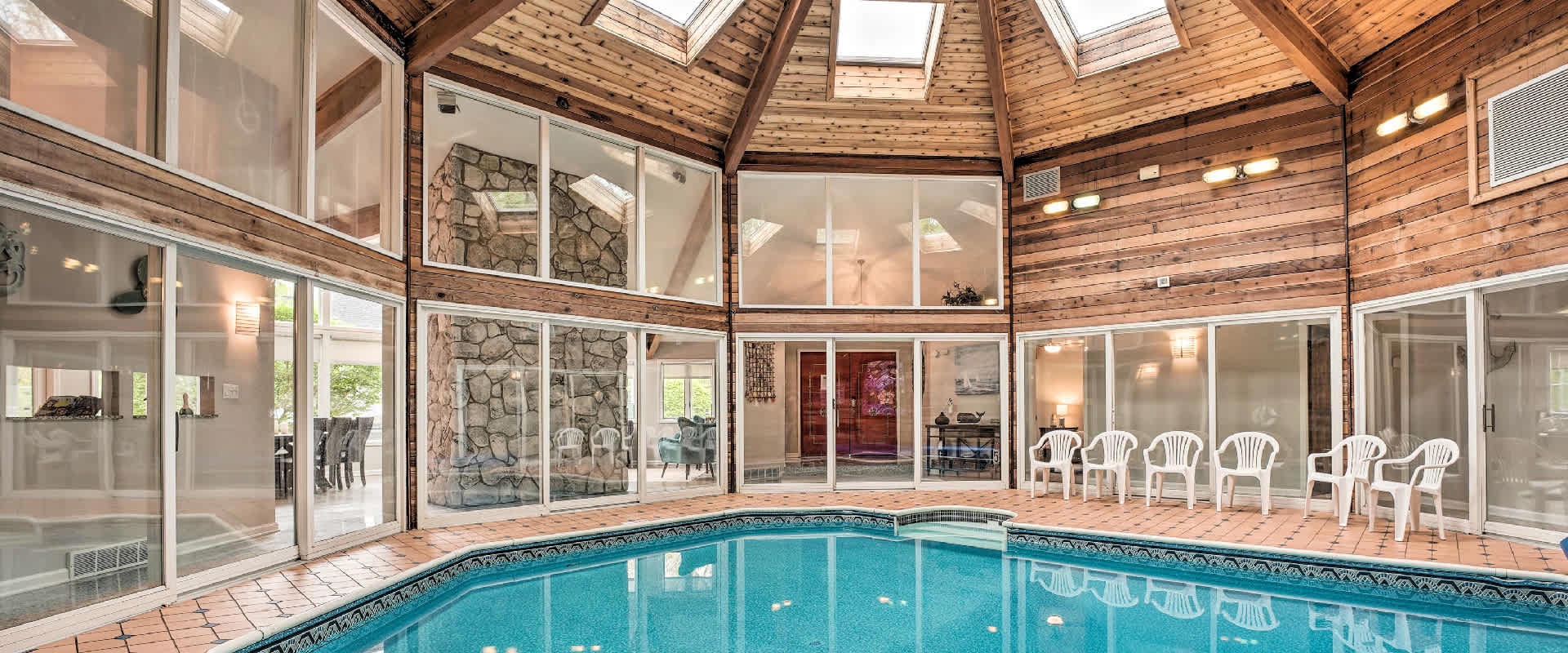 Photo of a large indoor pool in a vacation rental near Union Pier, Michigan. The open layout with windows allows a lot of light to fill up the fun space.