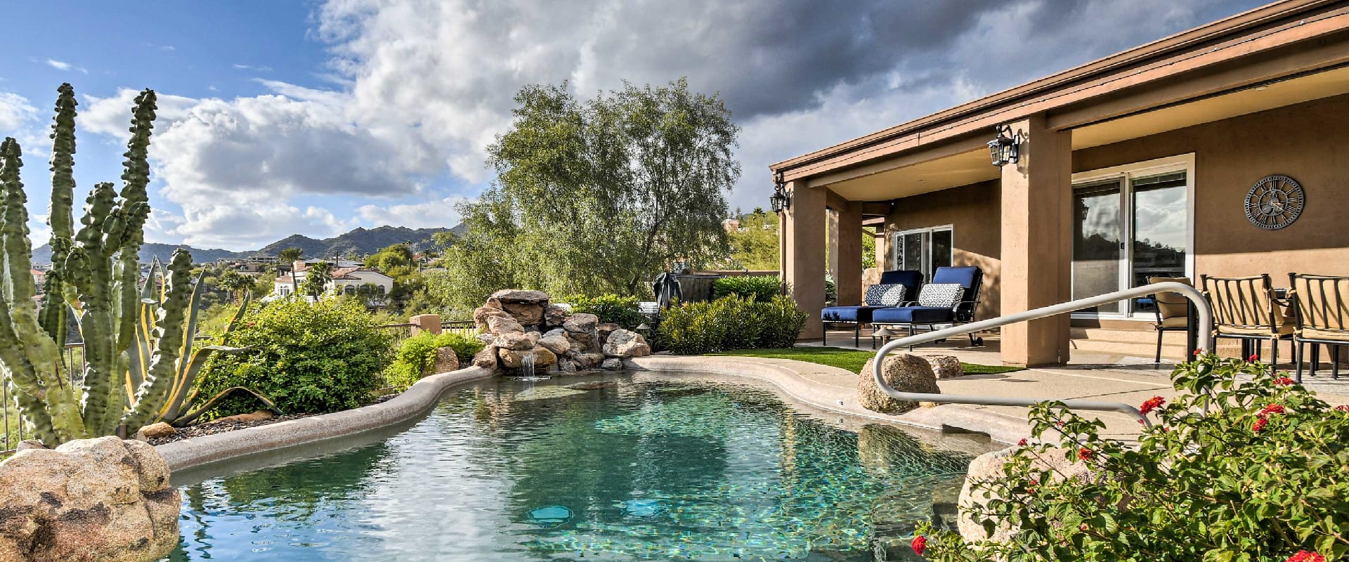 Vacation rental with private pool overlooking the Arizona mountains surrounded by cacti, palm trees, and bushes