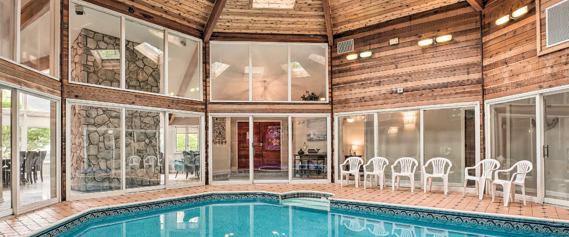 Large indoor pool in a vacation rental near Union Pier, MI. The open layout with windows allows a lot of light to fill up the fun space.