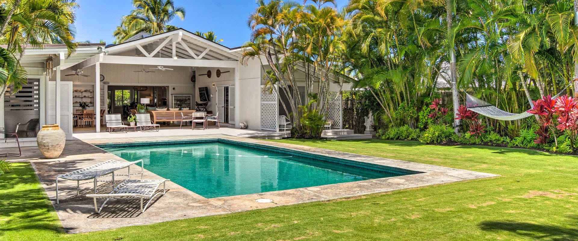 Outdoor pool surrounded by palm trees