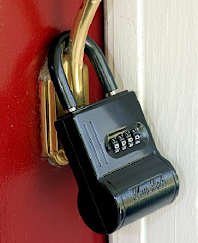 Programmable lockbox hanging over door handle