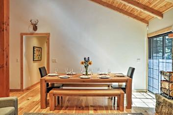 Vacation rental dining room with large dining table and warm wood accents