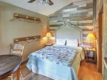 Vacation rental bedroom with wood wall accents and a table and chair