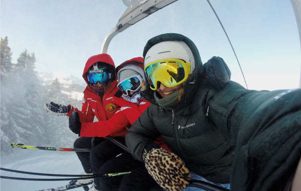 Skiers on a lift in winter apparel