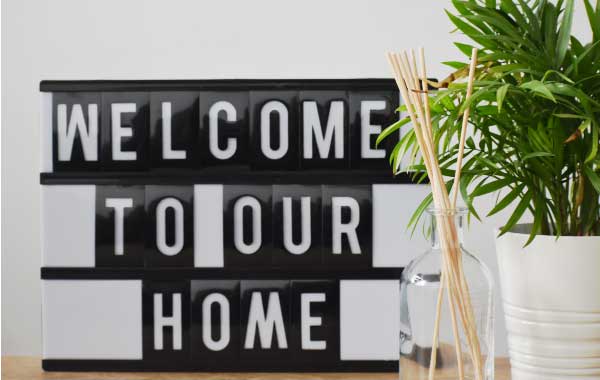 A "welcome to our home" sign as a vacation rental welcome gift idea