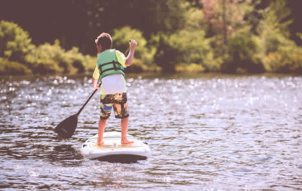 Young child paddleboarding on Table Rock Lake in Branson, MO