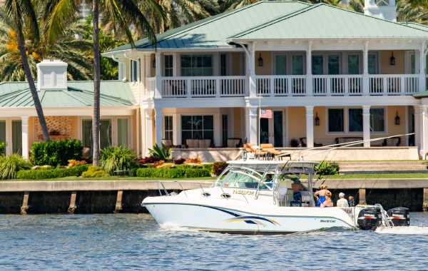 People on a boat tour by mansions in Fort Lauderdale, Florida