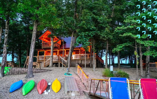 Vacation home with porch lights and kayaks near a shoreline