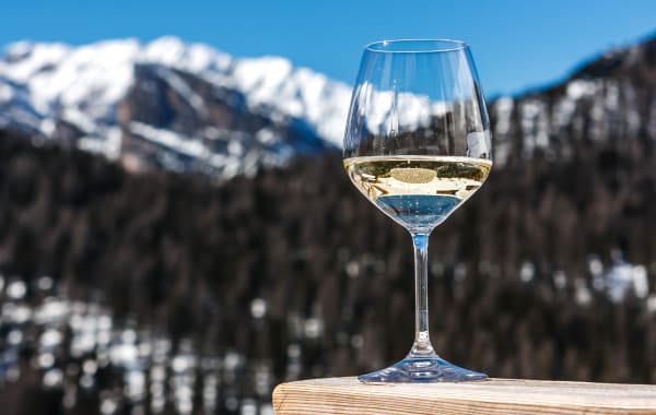 Glass of white wine with mountains in the background near Breckenridge, Colorado