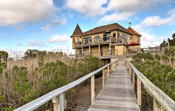 Wood walkway leading up to large beachfront vacation rental