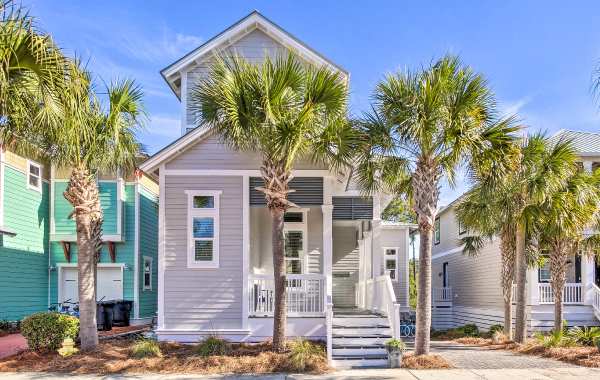 Modern beach house with palm trees on a clear day