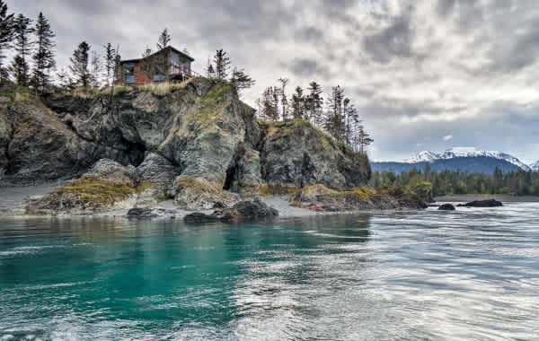 Luxurious vacation rental on top of a cliffside in Alaska overlooking the Alaska Range