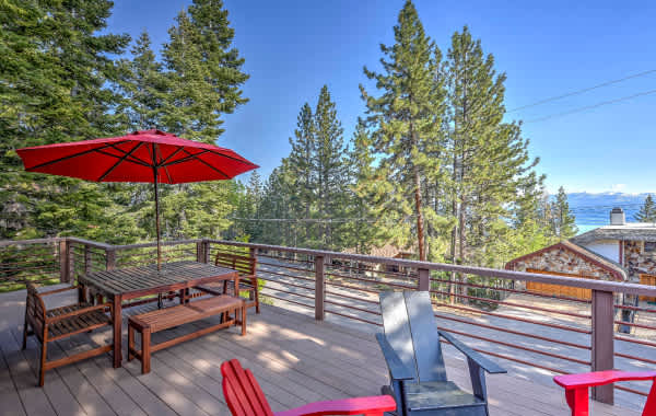 California lake house vacation rental deck surrounded by big pine trees