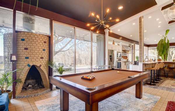 Modern home interior with vacation rental amenities like a pool table and unique brick fireplace