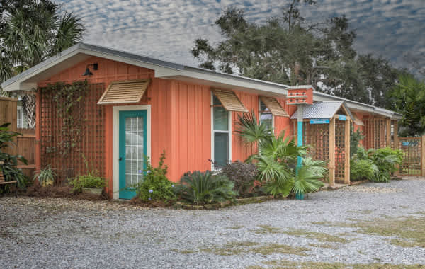 Image of a tropical vacation rental tiny home with lush greenery surrounding it