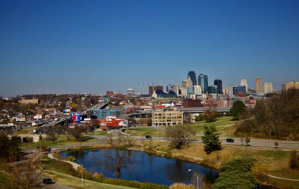 The Kansas City, Missouri skyline behind a park with pond