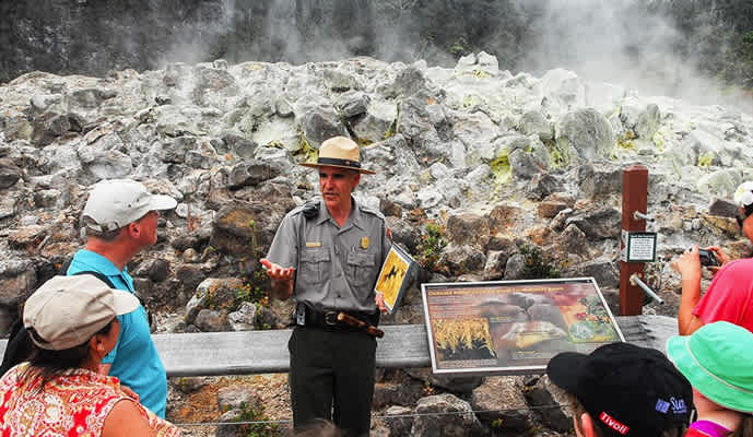 Tour guide talking with tour-goers in Hawai'i Volcanoes National Park