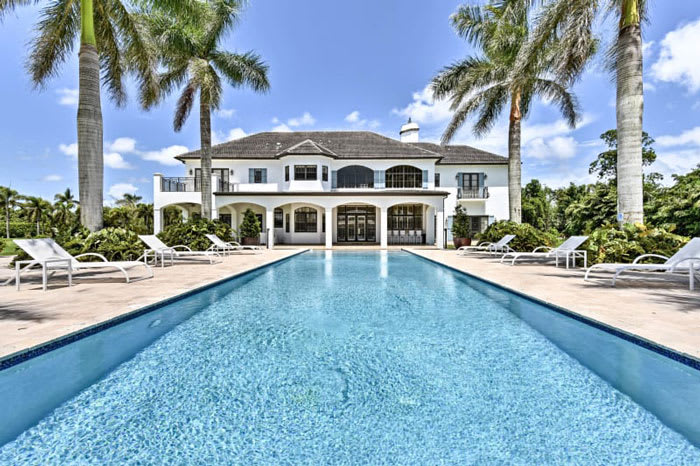 Palm tree-lined pool at luxury vacation rental in Homestead, Florida