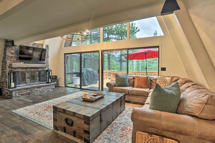 Living room with stone fireplace and nature views at Incline Village, Nevada vacation rental