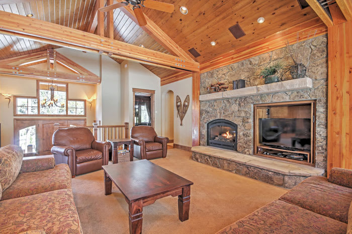 Rustic Breckenridge, Colorado cabin rental living room with large stone fireplace