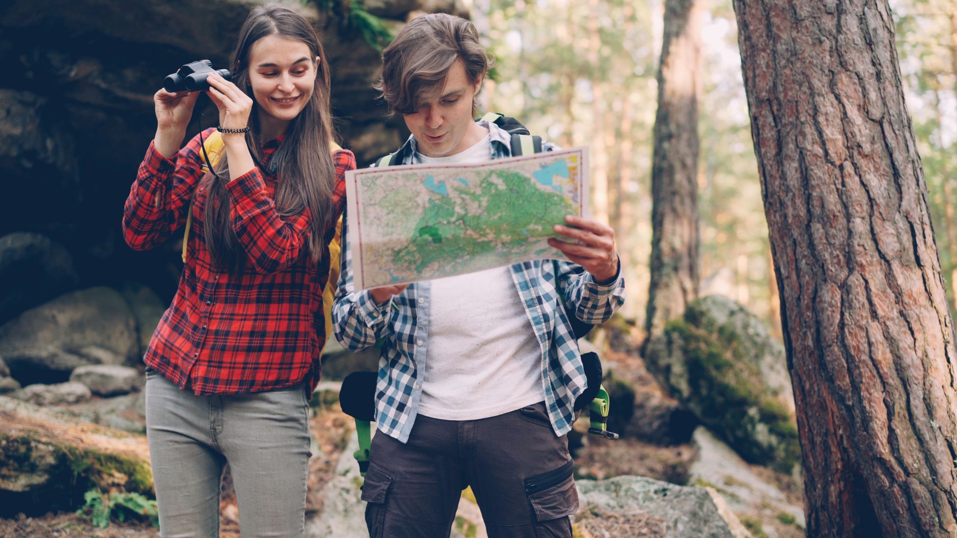 Young Hikers Exploring Forest with Map