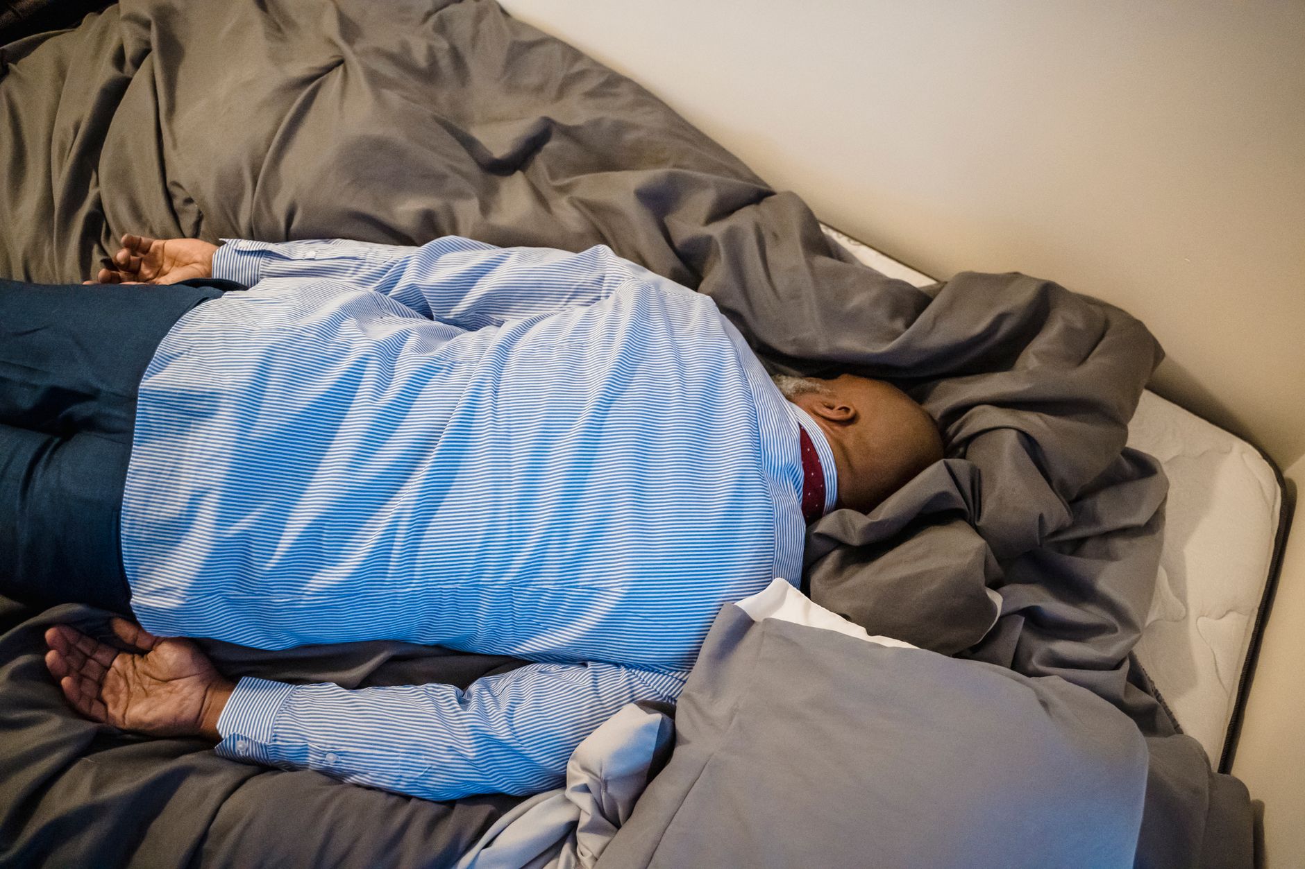 Tired Man in Formalwear Sleeping on Bed